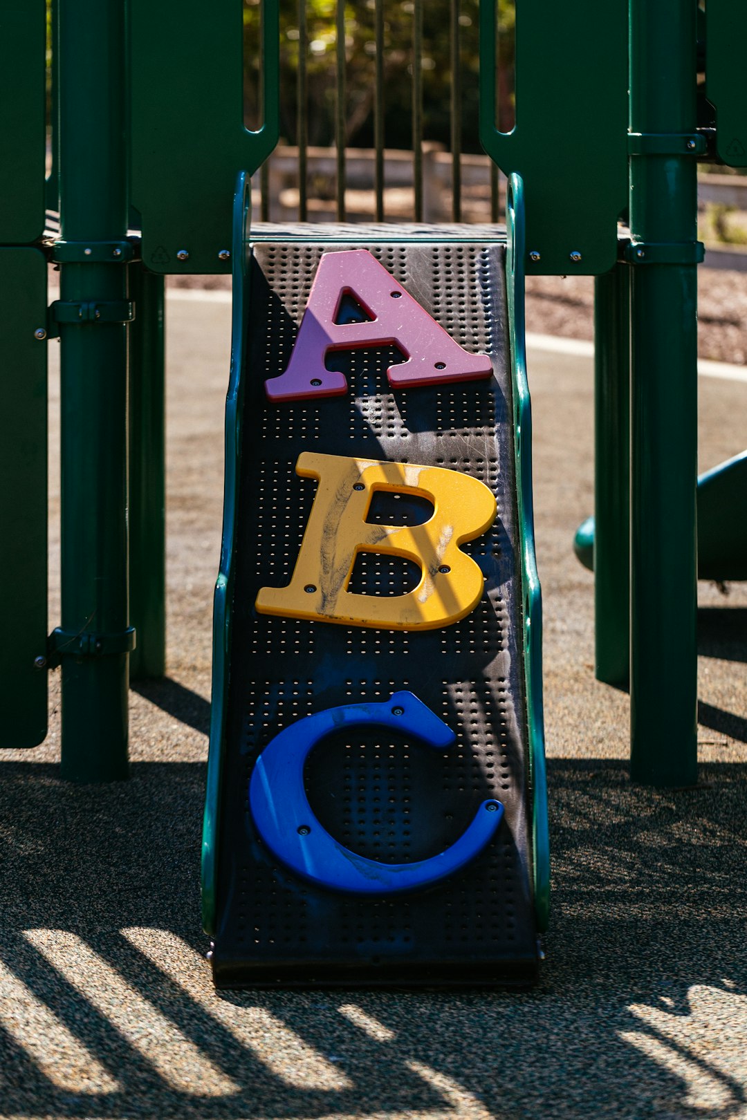a-playground-with-a-play-structure-with-letters-on-it-rwqbbrfzjjs