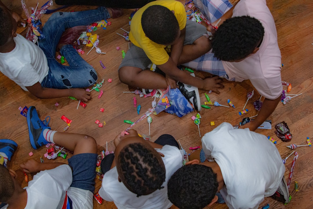 boys-eating-candies-while-sitting-on-floor-we1-kgqhplq